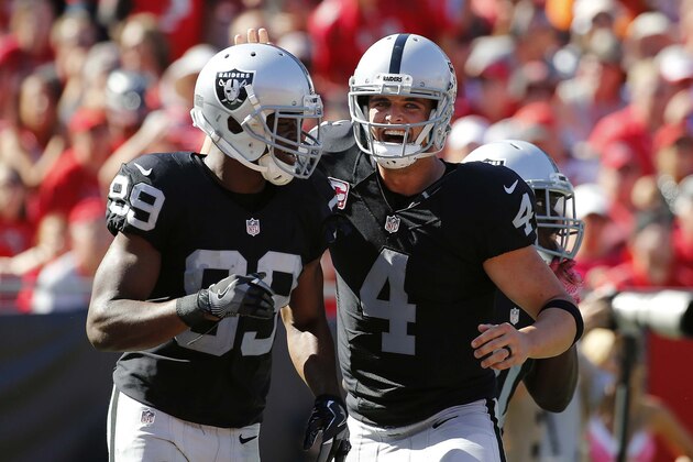 Oct 30, 2016; Tampa, FL, USA;  Oakland Raiders wide receiver Amari Cooper (89) and quarterback Derek Carr (4) congratulate each other after they scored a touchdown against the Tampa Bay Buccaneers during the second half at Raymond James Stadium. Oakland Raiders defeated the Tampa Bay Buccaneers 30-24 in overtime. Mandatory Credit: Kim Klement-USA TODAY Sports