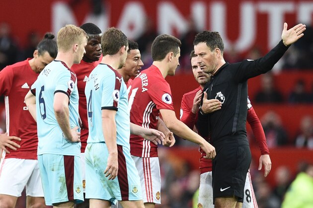 Referee Mark Clattenburg (R) gestures to Manchester United's Spanish midfielder Ander Herrera (2R) to leave the field after being sent off during the English Premier League football match between Manchester United and Burnley at Old Trafford in Manchester, north west England, on October 29, 2016. / AFP / OLI SCARFF / RESTRICTED TO EDITORIAL USE. No use with unauthorized audio, video, data, fixture lists, club/league logos or 'live' services. Online in-match use limited to 75 images, no video emulation. No use in betting, games or single club/league/player publications.  /         (Photo credit should read OLI SCARFF/AFP/Getty Images)