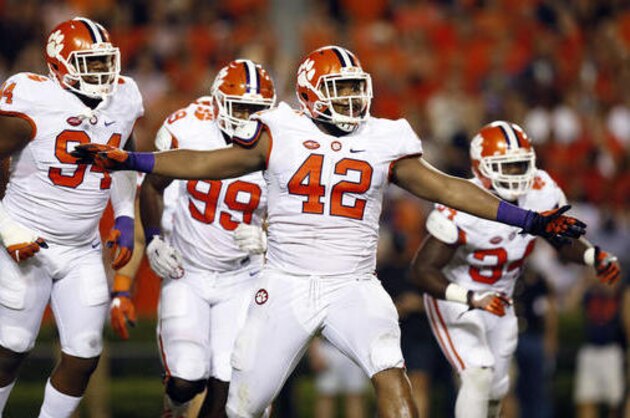 FILE - In this Sept. 3, 2016, file photo, Clemson defensive lineman Christian Wilkins celebrates after a Clemson sack of Auburn quarterback Jeremy Johnson during the first half of an NCAA college football game om Auburn, Ala. Four ACC teams rank 8th to 11th nationally in FBS total defense with Clemson, Louisville and Virginia Tech ranked and thinking about winning the conference. Several other schools have been impressive as well, helping to show the conference is about more than dynamic quarterbacks such as Louisville's Lamar Jackson and Clemson's Deshaun Watson. (AP Photo/Brynn Anderson, File)