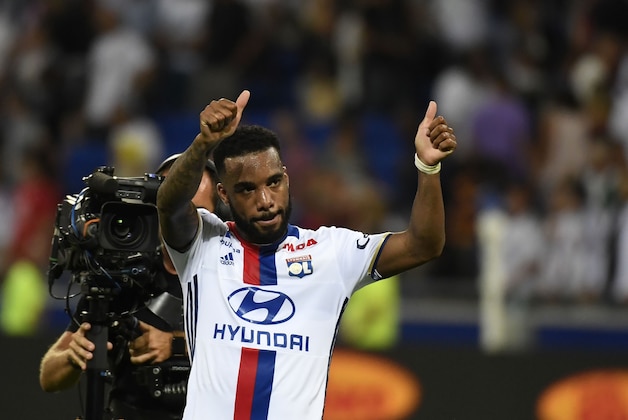 Lyon's French forward Alexandre Lacazette (L) gestures after scoring his second goal during the French Ligue 1 football match Olympique Lyonnais (OL) against Caen (SMC) on August 19, 2016, at the Parc Olympique Lyonnais stadium in Decines-Charpieu near Lyon, southeastern France.    / AFP / PHILIPPE DESMAZES        (Photo credit should read PHILIPPE DESMAZES/AFP/Getty Images)
