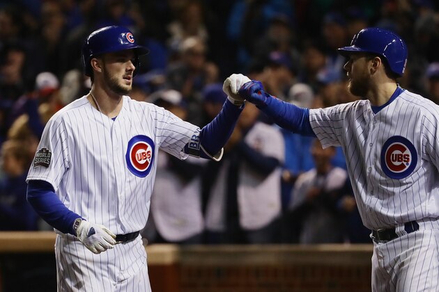 CHICAGO, IL - OCTOBER 30:  Kris Bryant #17 of the Chicago Cubs (L) is congratulated by Ben Zobrist #18 after Bryant hit a home run in the fourth inning against the Cleveland Indians in Game Five of the 2016 World Series at Wrigley Field on October 30, 2016 in Chicago, Illinois.  (Photo by Jonathan Daniel/Getty Images)
