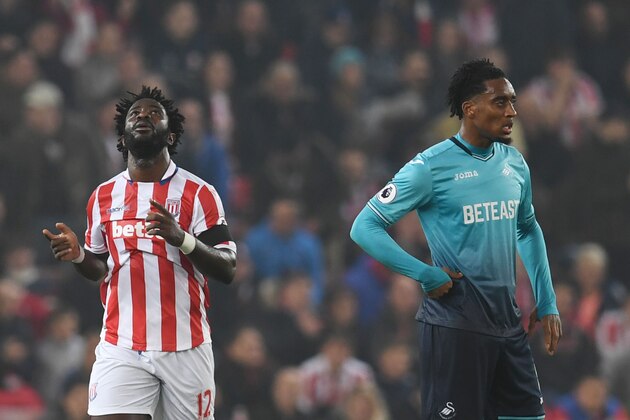 Stoke City's Ivorian striker Wilfried Bony (L) celebrates after scoring during the English Premier League football match between Stoke City and Swansea at the Bet365 Stadium in Stoke-on-Trent, central England on October 31, 2016. / AFP / PAUL ELLIS / RESTRICTED TO EDITORIAL USE. No use with unauthorized audio, video, data, fixture lists, club/league logos or 'live' services. Online in-match use limited to 75 images, no video emulation. No use in betting, games or single club/league/player publications.  /         (Photo credit should read PAUL ELLIS/AFP/Getty Images)