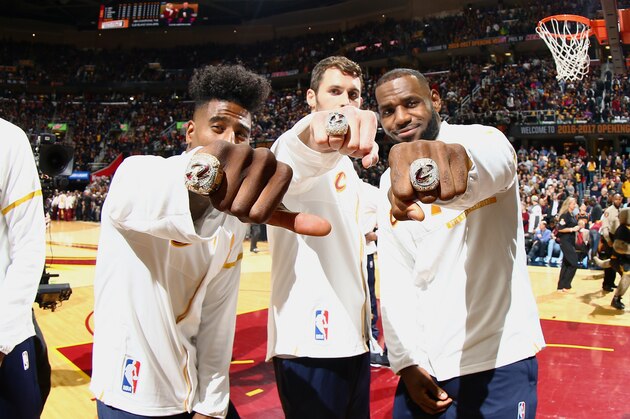 CLEVELAND, OH - OCTOBER 25:  Kevin Love #0, Iman Shumpert #4, and LeBron James #23 of the Cleveland Cavaliers show off their rings during the NBA Championship ring ceremony prior to the game of the Cleveland Cavaliers against the New York Knicks on October 25, 2016 at at Quicken Loans Arena in Cleveland, Ohio. NOTE TO USER: User expressly acknowledges and agrees that, by downloading and/or using this Photograph, user is consenting to the terms and conditions of the Getty Images License Agreement. Mandatory Copyright Notice: Copyright 2016 NBAE (Photo by Nathaniel S. Butler/NBAE via Getty Images)