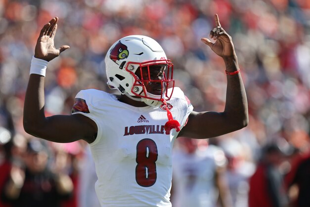 Oct 29, 2016; Charlottesville, VA, USA; Louisville Cardinals quarterback Lamar Jackson (8) celebrates after throwing a touchdown pass against the Virginia Cavaliers in the first quarter at Scott Stadium. Mandatory Credit: Geoff Burke-USA TODAY Sports
