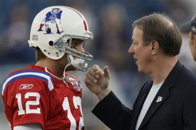 Former Buffalo Bills quarterback Jim Kelly, right, talks with New England Patriots quarterback Tom Brady before an NFL football game between the Bill and the Patriots on Monday, Sept. 14, 2009, in Foxborough, Mass. (AP Photo/Winslow Townson)