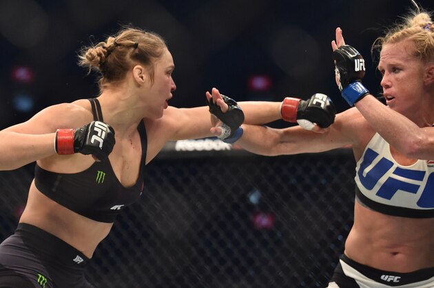 Ronda Rousey of the US (L) lines up compatriot Holly Holm (R) during the UFC title fight in Melbourne on November 15, 2015.   RESTRICTED TO EDITORIAL USE NO ADVERTISING USE NO PROMOTIONAL USE NO MERCHANDISING USE.  AFP PHOTO/Paul CROCK        (Photo credit should read PAUL CROCK/AFP/Getty Images)