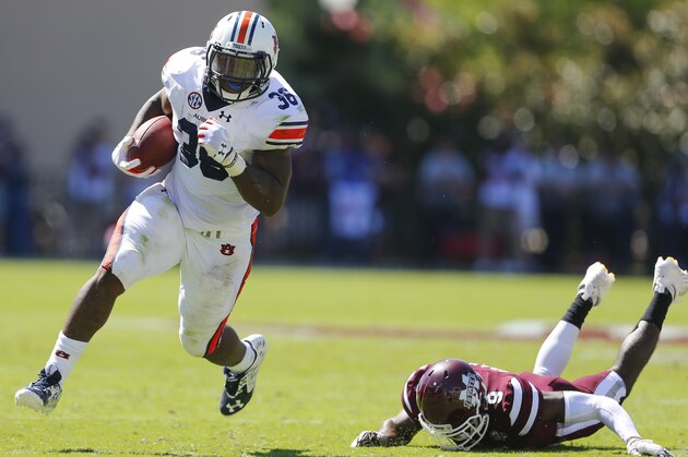 STARKVILLE, MS - OCTOBER 8:   Running back Kamryn Pettway #36 of the Auburn Tigers tries to get around defensive back Jamoral Graham #9 of the Mississippi State Bulldogs as he carries the ball during the first half of an NCAA college football game on Oct. 8, 2016 in Starkville, Mississippi. (Photo by Butch Dill/Getty Images)