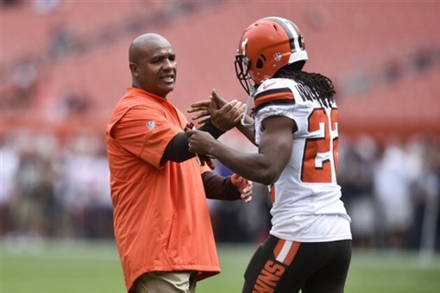 Cleveland Browns head coach Hue Jackson greets cornerback Tramon Williams, right, during practice before an NFL football game against the Baltimore Ravens, Sunday, Sept. 18, 2016, in Cleveland. (AP Photo/David Richard)