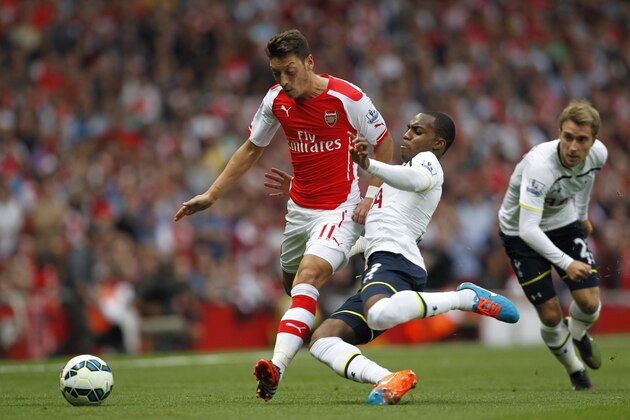 Arsenals German midfielder Mesut Ozil (L) is tackled by Tottenham Hotspurs English defender Danny Rose during the English Premier League football match between Arsenal and Tottenham Hotspur at The Emirates Stadium in London on on September 27, 2014.  AFP PHOTO/IAN KINGTON - RESTRICTED TO EDITORIAL USE. No use with unauthorized audio, video, data, fixture lists, club/league logos or live services. Online in-match use limited to 45 images, no video emulation. No use in betting, games or single club/league/player publications.        (Photo credit should read IAN KINGTON/AFP/Getty Images)