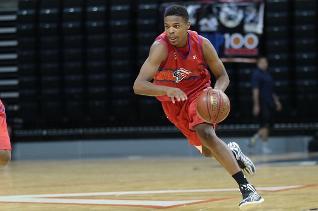 CHARLOTTESVILLE, VA - JUNE 18: Dennis Smith #13 in red brings the ball up the court during the National Basketball Players Association Top 100 Camp on June 19, 2014 at John Paul Jones Arena in Charlottesville, Virginia. (Photo by Kelly Kline/Getty Images)