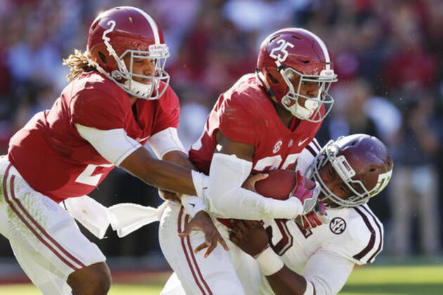 Texas A&M defensive lineman Myles Garrett tackles Alabama running back Joshua Jacobs during the hand off from quarterback Jalen Hurts, and during the first half of an NCAA college football game, Saturday, Oct. 22, 2016, in Tuscaloosa, Ala. (AP Photo/Brynn Anderson)