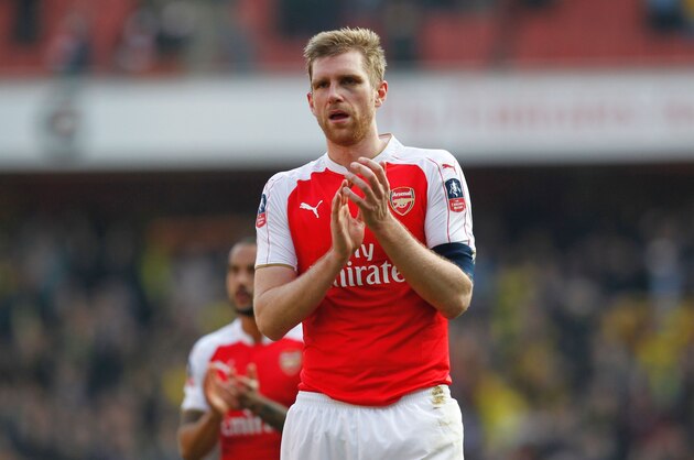 Arsenal's German defender Per Mertesacker appauds supporters after the English FA Cup quarter final football match between Arsenal and Watford at the Emirates Stadium in London on March 13, 2016. 
Watford won the game 2-1. / AFP / Ian Kington / RESTRICTED TO EDITORIAL USE. No use with unauthorized audio, video, data, fixture lists, club/league logos or 'live' services. Online in-match use limited to 75 images, no video emulation. No use in betting, games or single club/league/player publications.  /         (Photo credit should read IAN KINGTON/AFP/Getty Images)