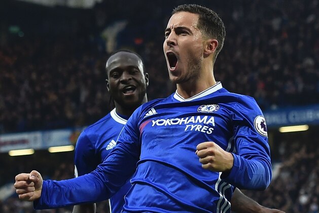 Chelsea's Belgian midfielder Eden Hazard celebrates with Chelsea's Nigerian midfielder Victor Moses after scoring their third goal during the English Premier League football match between Chelsea and Manchester United at Stamford Bridge in London on October 23, 2016. / AFP / Glyn KIRK / RESTRICTED TO EDITORIAL USE. No use with unauthorized audio, video, data, fixture lists, club/league logos or 'live' services. Online in-match use limited to 75 images, no video emulation. No use in betting, games or single club/league/player publications. / (Photo credit should read GLYN KIRK/AFP/Getty Images) Chelsea's Belgian midfielder Eden Hazard celebrates with Chelsea's Nigerian midfielder Victor Moses after scoring their third goal during the English Premier League football match between Chelsea and Manchester United at Stamford Bridge in London on October 23, 2016. / AFP / Glyn KIRK / RESTRICTED TO EDITORIAL USE. No use with unauthorized audio, video, data, fixture lists, club/league logos or 'live' services. Online in-match use limited to 75 images, no video emulation. No use in betting, games or single club/league/player publications. / (Photo credit should read GLYN KIRK/AFP/Getty Images)