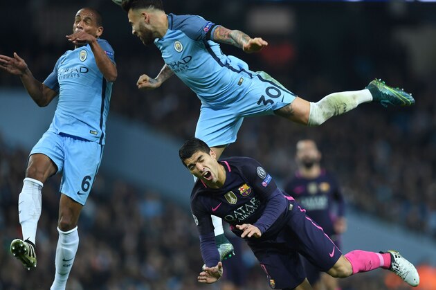 Barcelona's Uruguayan striker Luis Suarez (R) reacts after clashing with Manchester City's Brazilian midfielder Fernando (L) and Manchester City's Argentinian defender Nicolas Otamendi during the UEFA Champions League group C football match between Manchester City and Barcelona at the Etihad Stadium in Manchester, north west England on November 1, 2016. / AFP / PAUL ELLIS        (Photo credit should read PAUL ELLIS/AFP/Getty Images)