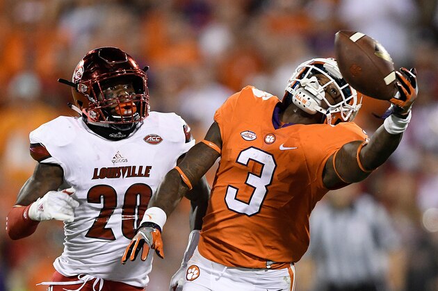 CLEMSON, SC - OCTOBER 01: Artavis Scott #3 of the Clemson Tigers attempts to make the catch under pressure from Ronald Walker #20 of the Louisville Cardinals during the fourth quarter at Memorial Stadium on October 1, 2016 in Clemson, South Carolina. The Clemson Tigers defeated the Louisville Cardinals 42-36.  (Photo by Grant Halverson/Getty Images)