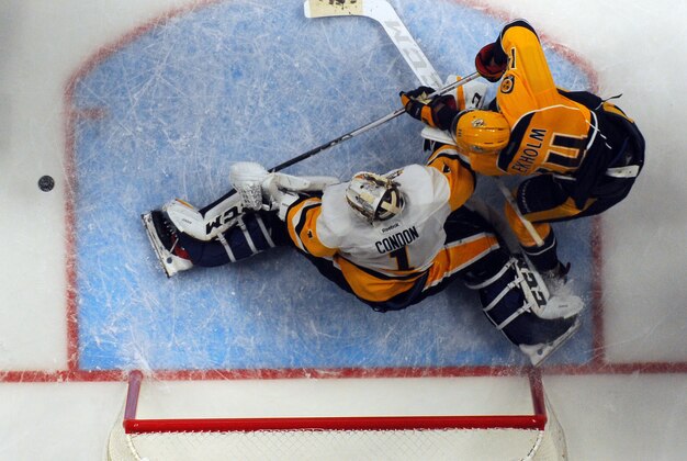 Oct 22, 2016; Nashville, TN, USA; Nashville Predators defenseman Mattias Ekholm (14) has a shot blocked by Pittsburgh Penguins goalie Mike Condon (1) during the third period at Bridgestone Arena. The Predators won 5-1. Mandatory Credit: Christopher Hanewinckel-USA TODAY Sports