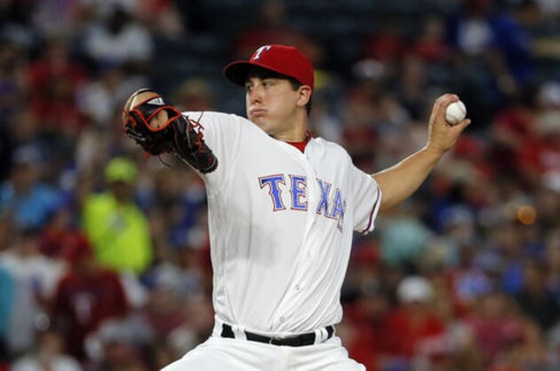 Texas Rangers starting pitcher Derek Holland (45) throws to the Los Angeles Angels in the second inning of a baseball game, Wednesday, Sept. 21, 2016, in Arlington, Texas. (AP Photo/Tony Gutierrez)