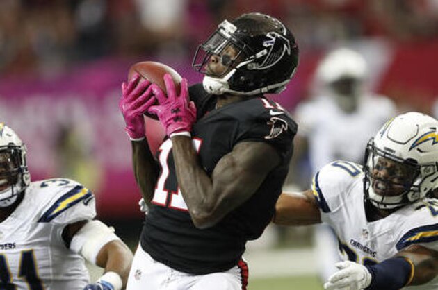 Atlanta Falcons wide receiver Julio Jones (11) makes the catch between San Diego Chargers free safety Dwight Lowery (20) and San Diego Chargers free safety Adrian Phillips (31) during the first half of an NFL football game, Sunday, Oct. 23, 2016, in Atlanta. (AP Photo/John Bazemore)