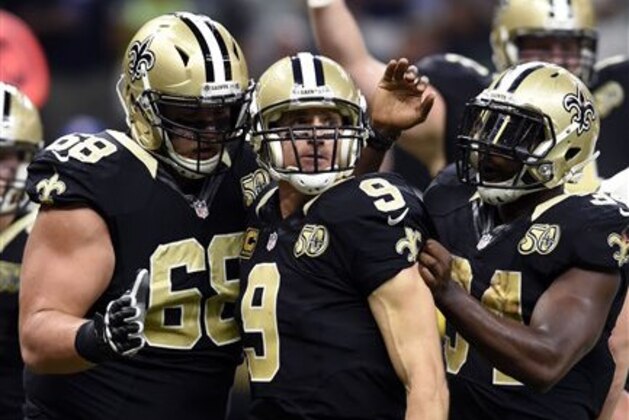 New Orleans Saints quarterback Drew Brees (9) celebrates his touchdown with offensive guard Tim Lelito (68) in the first half of an NFL football game against the Seattle Seahawks in New Orleans, Sunday, Oct. 30, 2016. (AP Photo/Bill Feig)