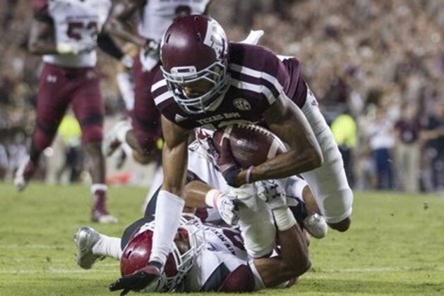 Texas A&M's Edward Pope (18) is tackled short of the goal line by New Mexico State's Jaden Wright (21) of an NCAA college football game Saturday, Oct. 29, 2016, in College Station, Texas. Texas A&M won 52-10. (AP Photo/Sam Craft)