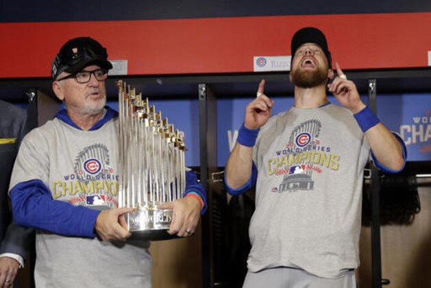 Chicago Cubs' Ben Zobrist, right, and manager Joe Maddon celebrate after Game 7 of the Major League Baseball World Series against the Cleveland Indians Thursday, Nov. 3, 2016, in Cleveland. The Cubs won 8-7 in 10 innings to win the series 4-3. (AP Photo/David J. Phillip)