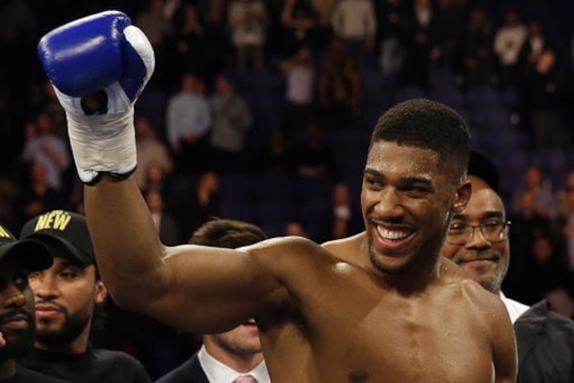 FILE - This is a Saturday, April 9, 2016 file photo of British boxer Anthony Joshua as he celebrates after winning the IBF heavyweight title bout against US boxer Charles Martinat the O2 Arena in London.  Joshua will make the second defense of his IBF world heavyweight title in a fight against American boxer Eric Molina on Dec. 10. Joshua’s promoters announced the fight on Tuesday Nov. 1, 2016. (AP Photo/Matt Dunham, File)