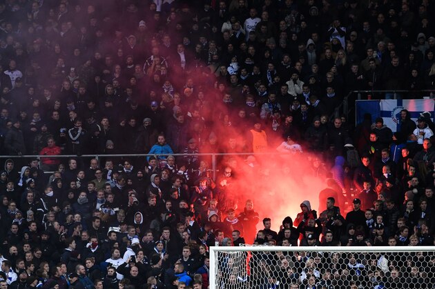 A flare burns as FC Copenhagen's supporters react at the end of the UEFA Champions League group G football match between FC Copenhagen and Leicester City FC at the Telia Parken stadium in Copenhagen on November 2, 2016.  / AFP / JONATHAN NACKSTRAND        (Photo credit should read JONATHAN NACKSTRAND/AFP/Getty Images)