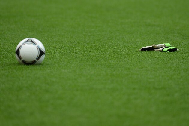 Golakeepers' gloves lays next to a football during a training session of the Polish team on June 7, 2012 at the National Stadium in Warsaw, on the eve of the Euro 2012 championship opening football match.   AFPPHOTO/ ARIS MESSINIS        (Photo credit should read ARIS MESSINIS/AFP/GettyImages)