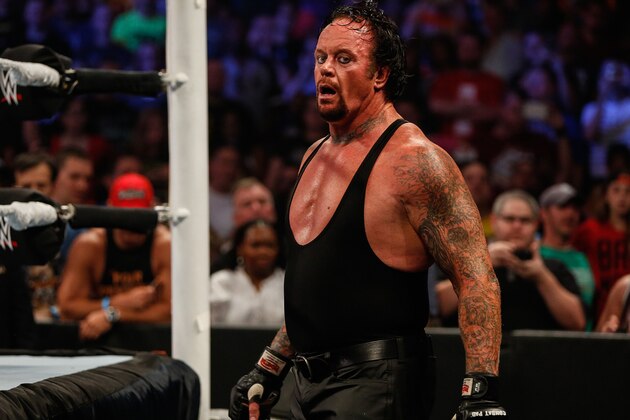 NEW YORK, NY - AUGUST 23: The Undertaker recovers during his fight against Brock Lesner at the WWE SummerSlam 2015 at Barclays Center of Brooklyn on August 23, 2015 in New York City.  (Photo by JP Yim/Getty Images)