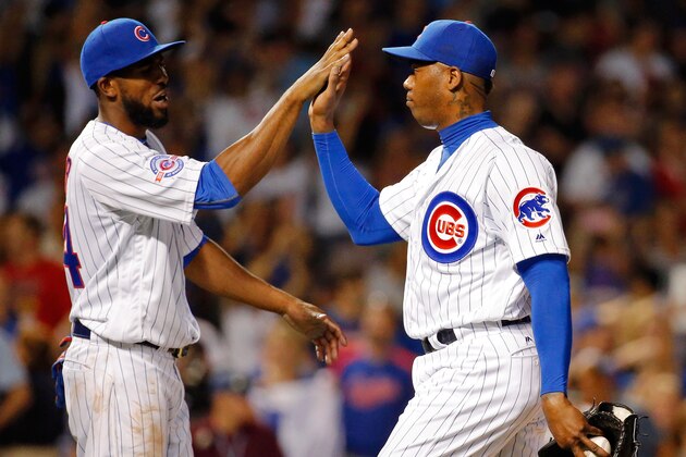 CHICAGO, IL - JULY 27: Dexter Fowler #24 (L) of the Chicago Cubs high fives Aroldis Chapman #54 after their win over the Chicago White Sox at Wrigley Field on July 27, 2016 in Chicago, Illinois. The Chicago Cubs won 8-1.  (Photo by Jon Durr/Getty Images)