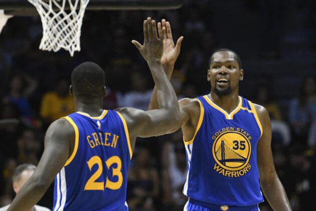 Golden State Warriors forward Kevin Durant (35) high-fives Draymond Green (23) after scoring during the second half of an NBA preseason basketball game against the Los Angeles Lakers on Wednesday, Oct. 19, 2016, in San Diego. (AP Photo/Denis Poroy)
