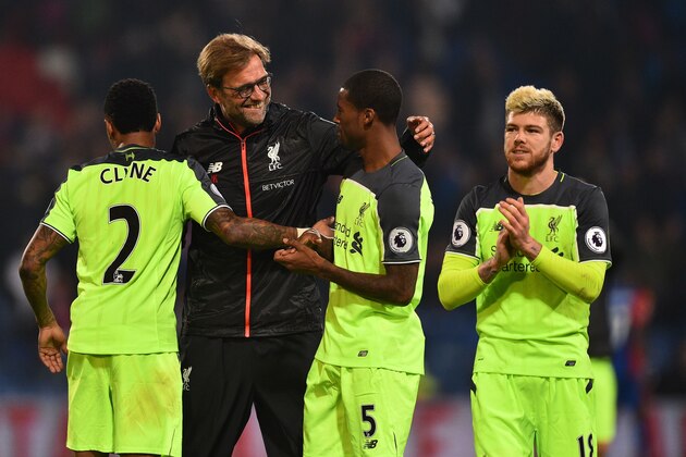 Liverpool's German manager Jurgen Klopp (2nd L) celebrates on the pitch with Liverpool's English defender Nathaniel Clyne (L), Liverpool's Dutch midfielder Georginio Wijnaldum and Liverpool's Spanish defender Alberto Moreno (R) after the English Premier League football match between Crystal Palace and Liverpool at Selhurst Park in south London on October 29, 2016.
Liverpool won the game 4-2. / AFP / Glyn KIRK / RESTRICTED TO EDITORIAL USE. No use with unauthorized audio, video, data, fixture lists, club/league logos or 'live' services. Online in-match use limited to 75 images, no video emulation. No use in betting, games or single club/league/player publications.  /         (Photo credit should read GLYN KIRK/AFP/Getty Images)