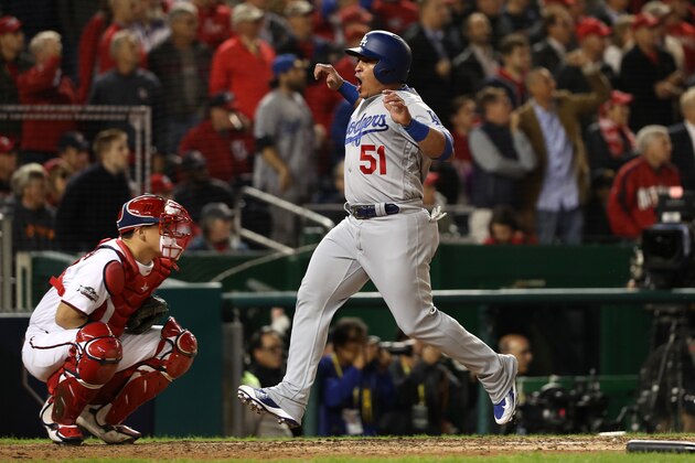 WASHINGTON, DC - OCTOBER 13: Carlos Ruiz #51 of the Los Angeles Dodgers celebrates after scoring off of a two run RBI triple hit by Justin Turner #10 (not pictured) in the seventh inning against the Washington Nationals during game five of the National League Division Series at Nationals Park on October 13, 2016 in Washington, DC. (Photo by Patrick Smith/Getty Images)