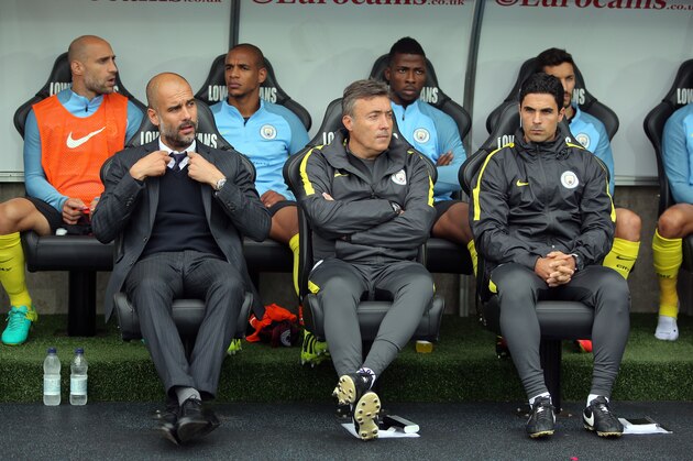 SWANSEA, WALES - SEPTEMBER 24: Manager of Manchester City, Pep Guardiola (L) with colleague Mikel Arteta (R) adjusts his tie during the Premier League match between Swansea City and Manchester City at The Liberty Stadium on September 24, 2016 in Swansea, Wales. (Photo by Athena Pictures/Getty Images)