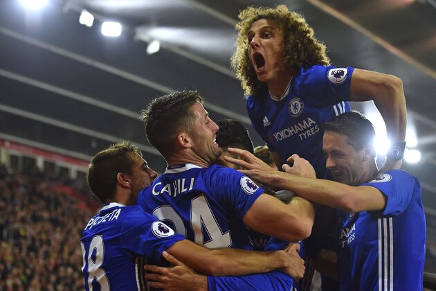 TOPSHOT - Chelsea's Brazilian defender David Luiz (2R) jumps in to celebrate their second goal scored by Chelsea's Brazilian-born Spanish striker Diego Costa (C obscured) during the English Premier League football match between Southampton and Chelsea at St Mary's Stadium in Southampton, southern England on October 30, 2016. / AFP / GLYN KIRK / RESTRICTED TO EDITORIAL USE. No use with unauthorized audio, video, data, fixture lists, club/league logos or 'live' services. Online in-match use limited to 75 images, no video emulation. No use in betting, games or single club/league/player publications.  /         (Photo credit should read GLYN KIRK/AFP/Getty Images)