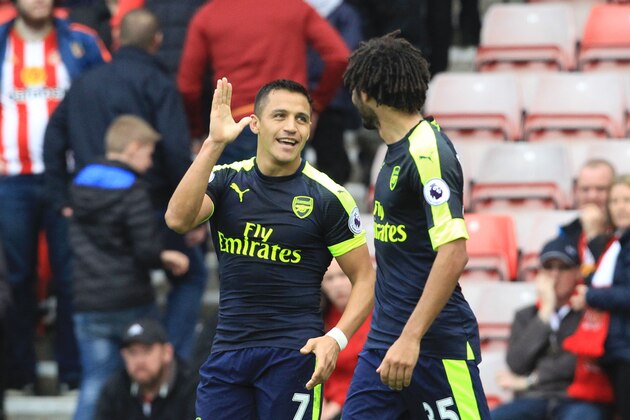 Arsenal's Chilean striker Alexis Sanchez (L) celebrates scoring thir fourth goal during the English Premier League football match between Sunderland and Arsenal at the Stadium of Light in Sunderland, northeast England on October 29, 2016. / AFP / Lindsey PARNABY / RESTRICTED TO EDITORIAL USE. No use with unauthorized audio, video, data, fixture lists, club/league logos or 'live' services. Online in-match use limited to 75 images, no video emulation. No use in betting, games or single club/league/player publications.  /         (Photo credit should read LINDSEY PARNABY/AFP/Getty Images)