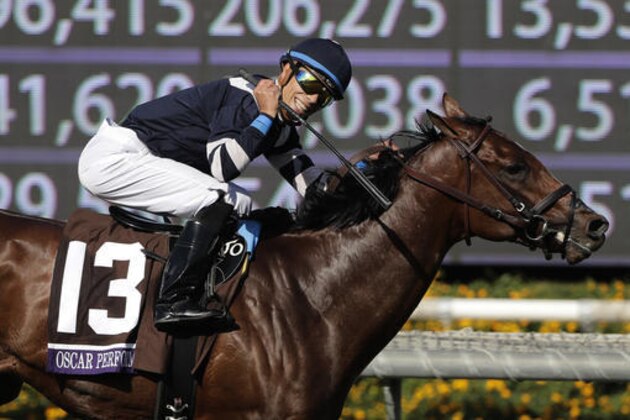 Jockey Jose Ortiz celebrates after riding Oscar Performance to victory in the Breeders' Cup Juvenile Turf horse race at Santa Anita, Friday, Nov. 4, 2016, in Arcadia, Calif. (AP Photo/Jae C. Hong)