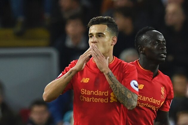 Liverpool's Brazilian midfielder Philippe Coutinho (L) celebrates scoring their second goal with Liverpool's Senegalese midfielder Sadio Mane (R) during the English Premier League football match between Liverpool and West Bromwich Albion at Anfield in Liverpool, north west England on October 22, 2016. / AFP / PAUL ELLIS / RESTRICTED TO EDITORIAL USE. No use with unauthorized audio, video, data, fixture lists, club/league logos or 'live' services. Online in-match use limited to 75 images, no video emulation. No use in betting, games or single club/league/player publications.  /         (Photo credit should read PAUL ELLIS/AFP/Getty Images)