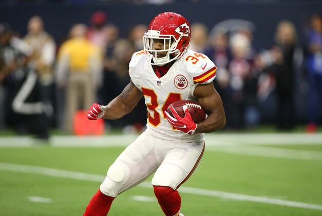 Jan 9, 2016; Houston, TX, USA; Kansas City Chiefs running back Knile Davis (34) returns the opening kickoff for a touchdown against the Houston Texans during the first quarter in a AFC Wild Card playoff football game at NRG Stadium. Mandatory Credit: Troy Taormina-USA TODAY Sports