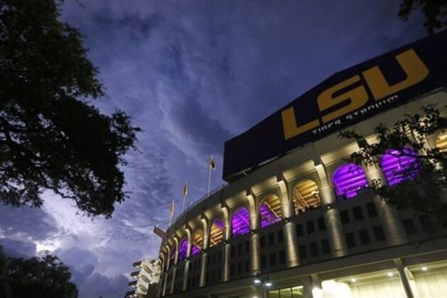 Lightning strikes near Tiger Stadium during a weather delay at an NCAA college football game between LSU and McNeese State in Baton Rouge, La., Saturday, Sept. 5, 2015. (AP Photo/Jonathan Bachman)
