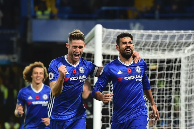 Chelsea's Brazilian-born Spanish striker Diego Costa (R) celebrates with Chelsea's English defender Gary Cahill after scoring their third gioal during the English Premier League football match between Chelsea and Everton at Stamford Bridge in London on November 5, 2016. / AFP / Glyn KIRK / RESTRICTED TO EDITORIAL USE. No use with unauthorized audio, video, data, fixture lists, club/league logos or 'live' services. Online in-match use limited to 75 images, no video emulation. No use in betting, games or single club/league/player publications.  /         (Photo credit should read GLYN KIRK/AFP/Getty Images)