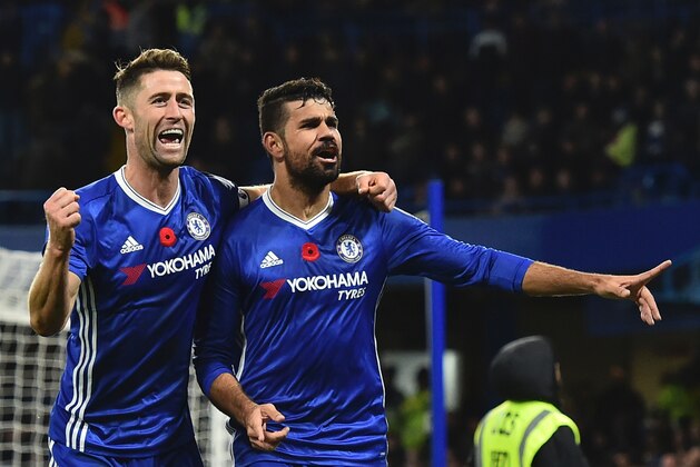 Chelsea's Brazilian-born Spanish striker Diego Costa (R) celebrates with Chelsea's English defender Gary Cahill after scoring their third goal during the English Premier League football match between Chelsea and Everton at Stamford Bridge in London on November 5, 2016. / AFP / Glyn KIRK / RESTRICTED TO EDITORIAL USE. No use with unauthorized audio, video, data, fixture lists, club/league logos or 'live' services. Online in-match use limited to 75 images, no video emulation. No use in betting, games or single club/league/player publications.  /         (Photo credit should read GLYN KIRK/AFP/Getty Images)