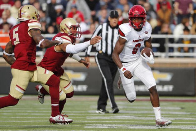 Louisville quarterback Lamar Jackson, right, runs past Boston College's Kamrin Moore (5) and Harold Landry during the first half of an NCAA football game at Alumni Stadium in Boston, Saturday, Nov. 5, 2016. (AP Photo/Winslow Townson)