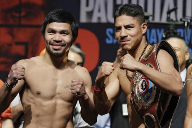 Manny Pacquiao, left, of the Philippines, and Jessie Vargas pose during a weigh-in, Friday, Nov. 4, 2016, in Las Vegas. The two are scheduled to fight in a welterweight title bout Saturday in Las Vegas. (AP Photo/John Locher)