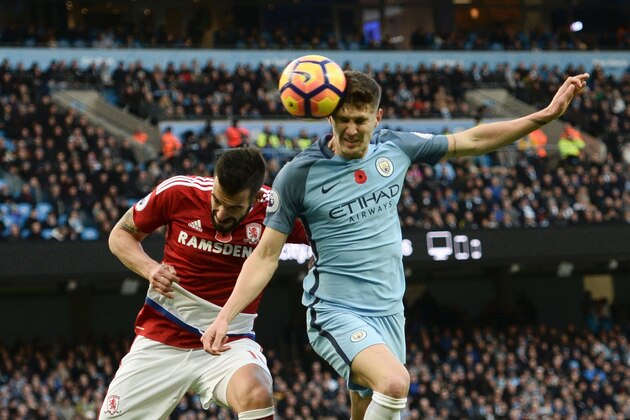 Manchester City's English defender John Stones (R) beats Middlesbrough's Spanish striker Alvaro Negredo (L) to a header during the English Premier League football match between Manchester City and Middlesbrough at the Etihad Stadium in Manchester, north west England, on November 5, 2016. / AFP / OLI SCARFF / RESTRICTED TO EDITORIAL USE. No use with unauthorized audio, video, data, fixture lists, club/league logos or 'live' services. Online in-match use limited to 75 images, no video emulation. No use in betting, games or single club/league/player publications.  /         (Photo credit should read OLI SCARFF/AFP/Getty Images)
