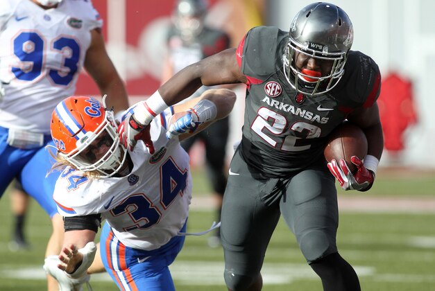 Nov 5, 2016; Fayetteville, AR, USA;  Arkansas Razorbacks running back Rawleigh Williams III (22) is tackled by Florida Gators linebacker Alex Anzalone (34) during the second quarter at Donald W. Reynolds Razorback Stadium. The play was called back due to penalty. Mandatory Credit: Nelson Chenault-USA TODAY Sports