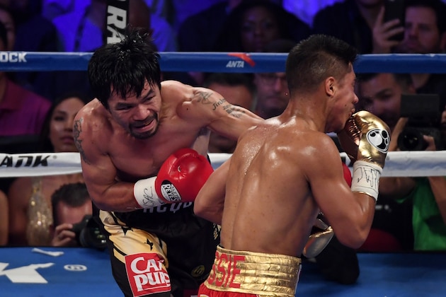LAS VEGAS, NV - NOVEMBER 05:  Manny Pacquiao (L) knocks Jessie Vargas down with a left in the second round of their WBO welterweight championship fight at the Thomas & Mack Center on November 5, 2016 in Las Vegas, Nevada.  (Photo by Ethan Miller/Getty Images)