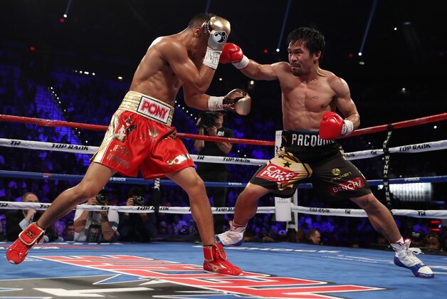 LAS VEGAS, NV - NOVEMBER 05:   (R-L) Manny Pacquiao of the Philippines throws a right to the head of Jessie Vargas during their WBO welterweight championship fight at the Thomas & Mack Center on November 5, 2016 in Las Vegas, Nevada. (Photo by Christian Petersen/Getty Images)