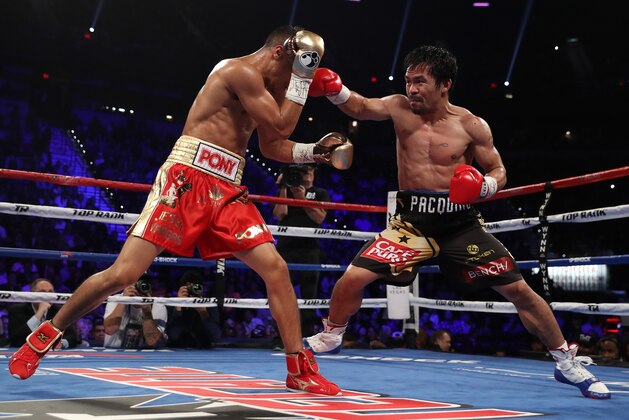 LAS VEGAS, NV - NOVEMBER 05:   (R-L) Manny Pacquiao of the Philippines throws a right to the head of Jessie Vargas during their WBO welterweight championship fight at the Thomas & Mack Center on November 5, 2016 in Las Vegas, Nevada. (Photo by Christian Petersen/Getty Images)