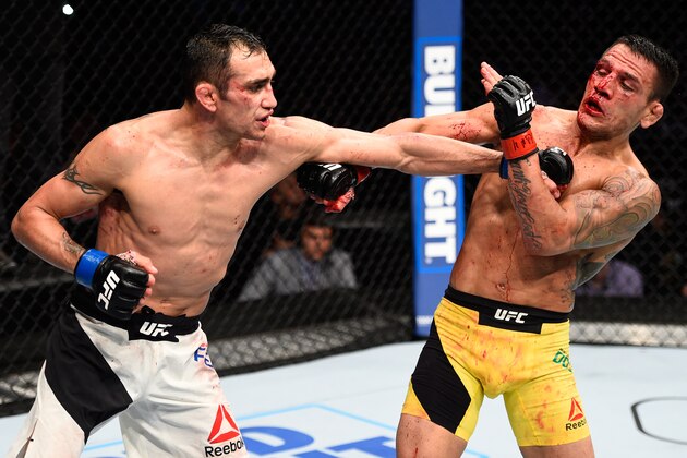MEXICO CITY, MEXICO - NOVEMBER 05:  (L-R) Tony Ferguson of the United States punches Rafael Dos Anjos of Brazil in their lightweight bout during the UFC Fight Night event at Arena Ciudad de Mexico on November 5, 2016 in Mexico City, Mexico. (Photo by Jeff Bottari/Zuffa LLC/Zuffa LLC via Getty Images)